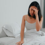 Unhealthy sick Indian female suffers from insomnia. Asian young